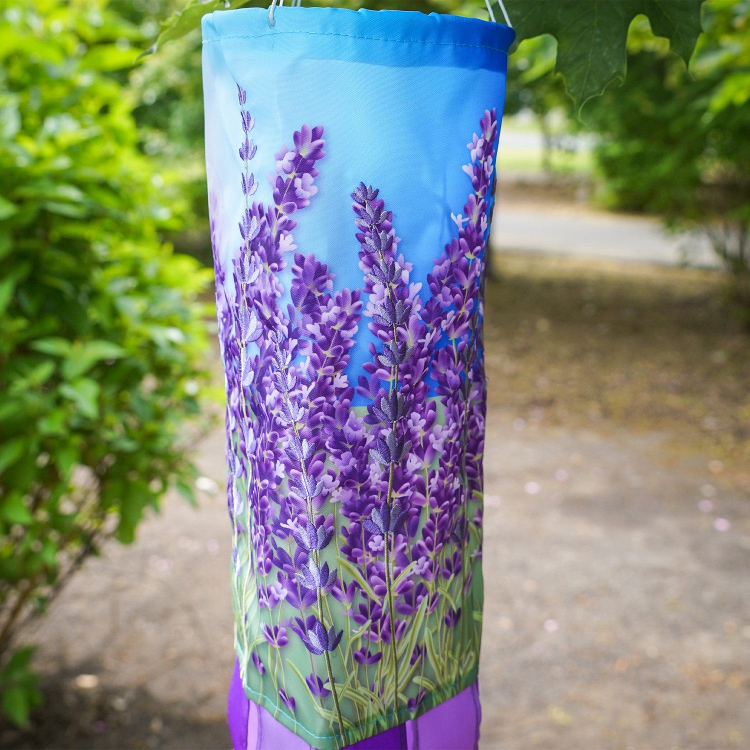 Lavender 40' Inspiration Windsock featuring vibrant colors and detailed designs, gracefully hanging outdoors ready to catch the breeze.