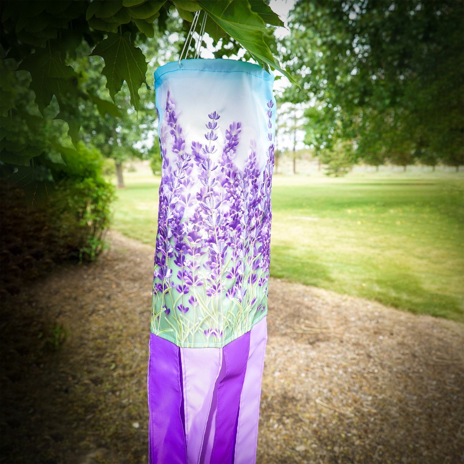 Lavender 40' Inspiration Windsock featuring vibrant colors and detailed designs, gracefully hanging outdoors ready to catch the breeze.