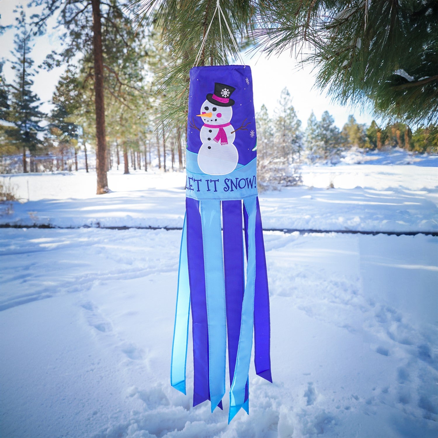 Let It Snow windsock featuring a cheerful snowman design with fluttering tails, perfect for festive winter outdoor decor that adds seasonal charm.