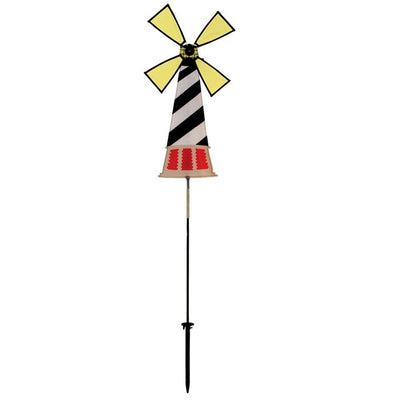 Lighthouse Spinner featuring Hatteras Lighthouse design, displayed outdoors with a colorful, rotating four-panel wheel in a garden setting.