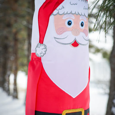 Lil' Santa Claus 3D 40" Windsock with vibrant colors, complete with free-flowing arms and tails, hanging outdoors to celebrate the holiday season.