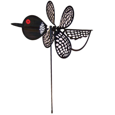 Loon Baby Spinner with colorful baby loons on a 12-inch wheel, spinning gracefully on a 17-inch fiberglass pole in an outdoor garden setting.