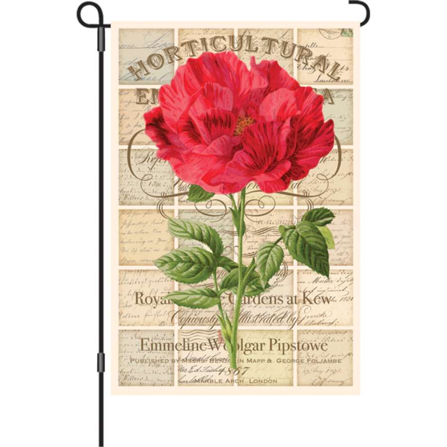 12 in. Love Letter Rose garden flag features a beautiful rose design displayed on a flag stand in a lush garden setting.