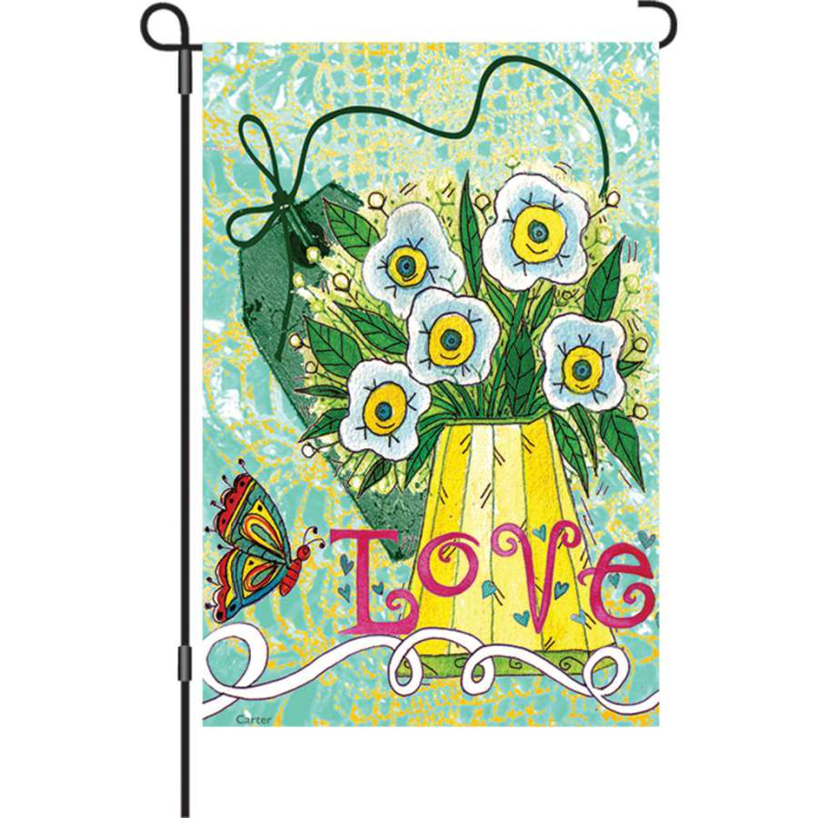 12 in. Love Makes Me Happy garden flag featuring colorful text displayed in a garden setting, swaying gently in the breeze.