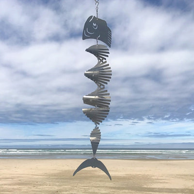 Mahi-mahi Shimmer Helix Spinner made of stainless steel, showcasing a helix design with shimmering fish head and tail, displayed outdoors.