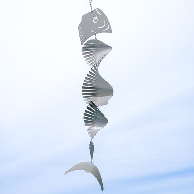 Mahi-mahi Shimmer Helix Spinner made of stainless steel, showcasing a helix design with shimmering fish head and tail, displayed outdoors.