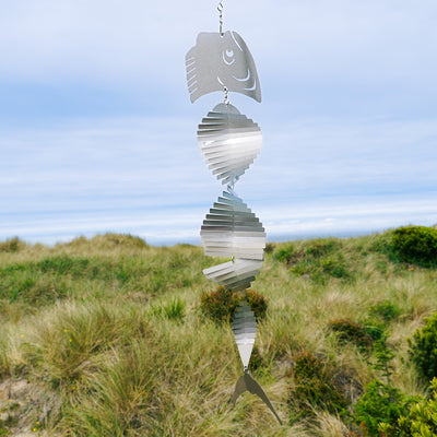 Mahi-mahi Shimmer Helix Spinner made of stainless steel, showcasing a helix design with shimmering fish head and tail, displayed outdoors.