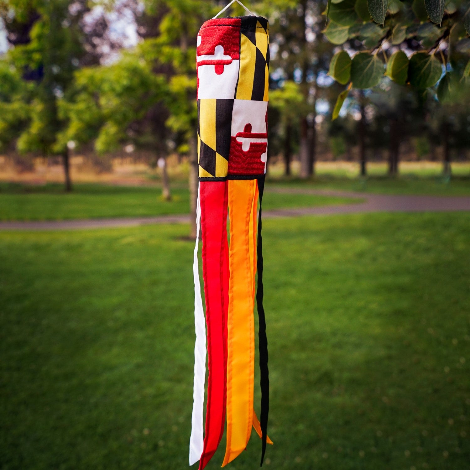 Maryland 18-inch windsock with colorful design and six fluttering tails displayed outdoors, showcasing its vibrant, weather-resistant features.