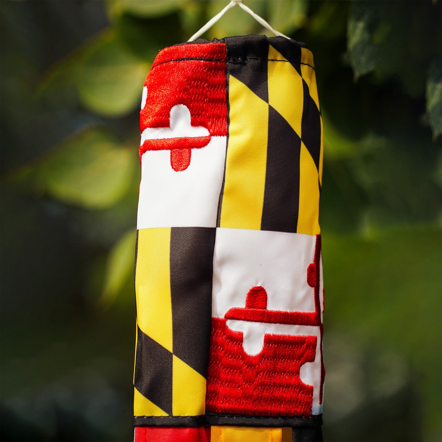 Maryland 18-inch windsock with colorful design and six fluttering tails displayed outdoors, showcasing its vibrant, weather-resistant features.