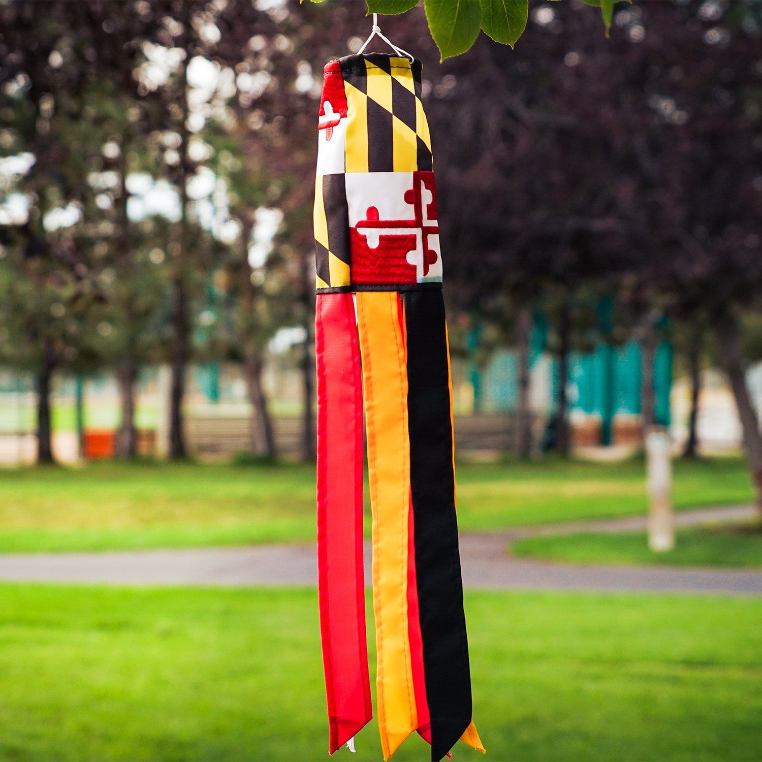 Maryland 18-inch windsock with colorful design and six fluttering tails displayed outdoors, showcasing its vibrant, weather-resistant features.