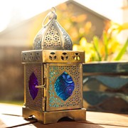 Medium Pink & Teal Square Glass Tealight Lantern showcasing intricate design, placed on a patio table with tealight candle inside.