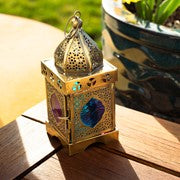 Medium Pink & Teal Square Glass Tealight Lantern showcasing intricate design, placed on a patio table with tealight candle inside.