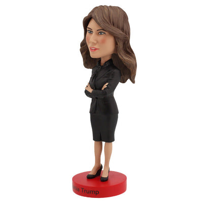 Melania Trump Bobblehead standing 7 inches tall, showcasing intricate details of her elegant attire and signature hairstyle on a display shelf.