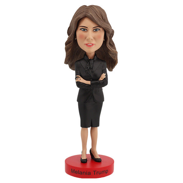Melania Trump Bobblehead standing 7 inches tall, showcasing intricate details of her elegant attire and signature hairstyle on a display shelf.