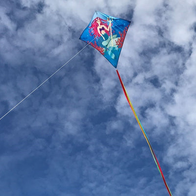 Mermaid 30" Diamond Kite flying in a clear blue sky, featuring bright colors and detailed graphics, ideal for kids and adults alike.