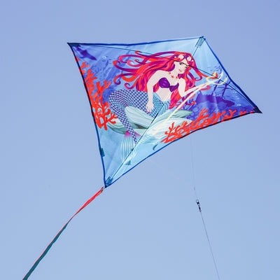 Mermaid 30" Diamond Kite flying in a clear blue sky, featuring bright colors and detailed graphics, ideal for kids and adults alike.