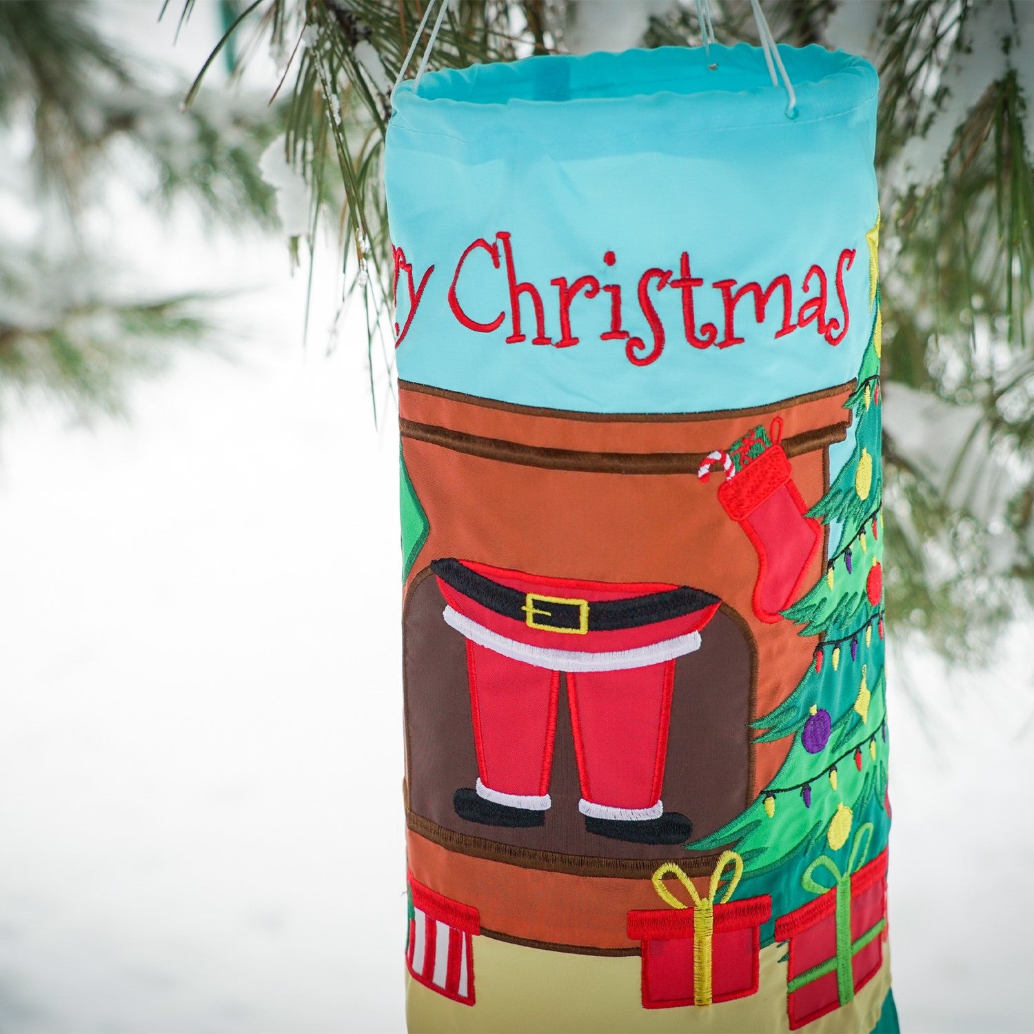 Merry Christmas 40" Windsock featuring a jolly Santa design with colorful tails fluttering in the breeze, ideal for festive outdoor decoration.