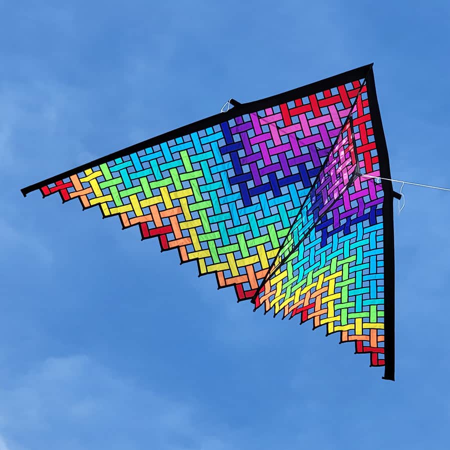 Oversized rainbow delta kite with colorful mesh pattern and durable carbon frame, perfect for beach flying in 5–20 mph winds.