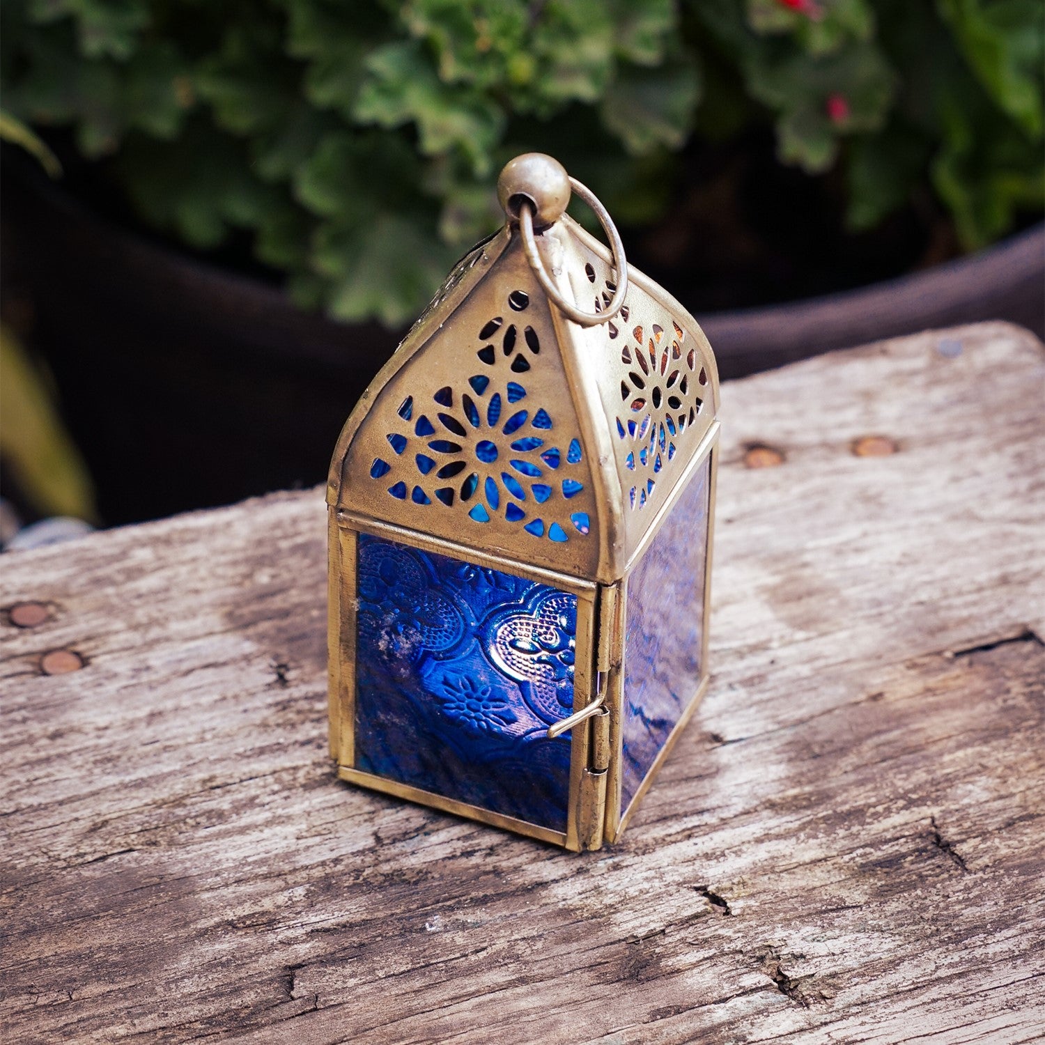 Mini Blue Square Glass Tealight Lantern with textured blue glass panels and a brass top, perfect for creating ambient lighting both indoors and outdoors.