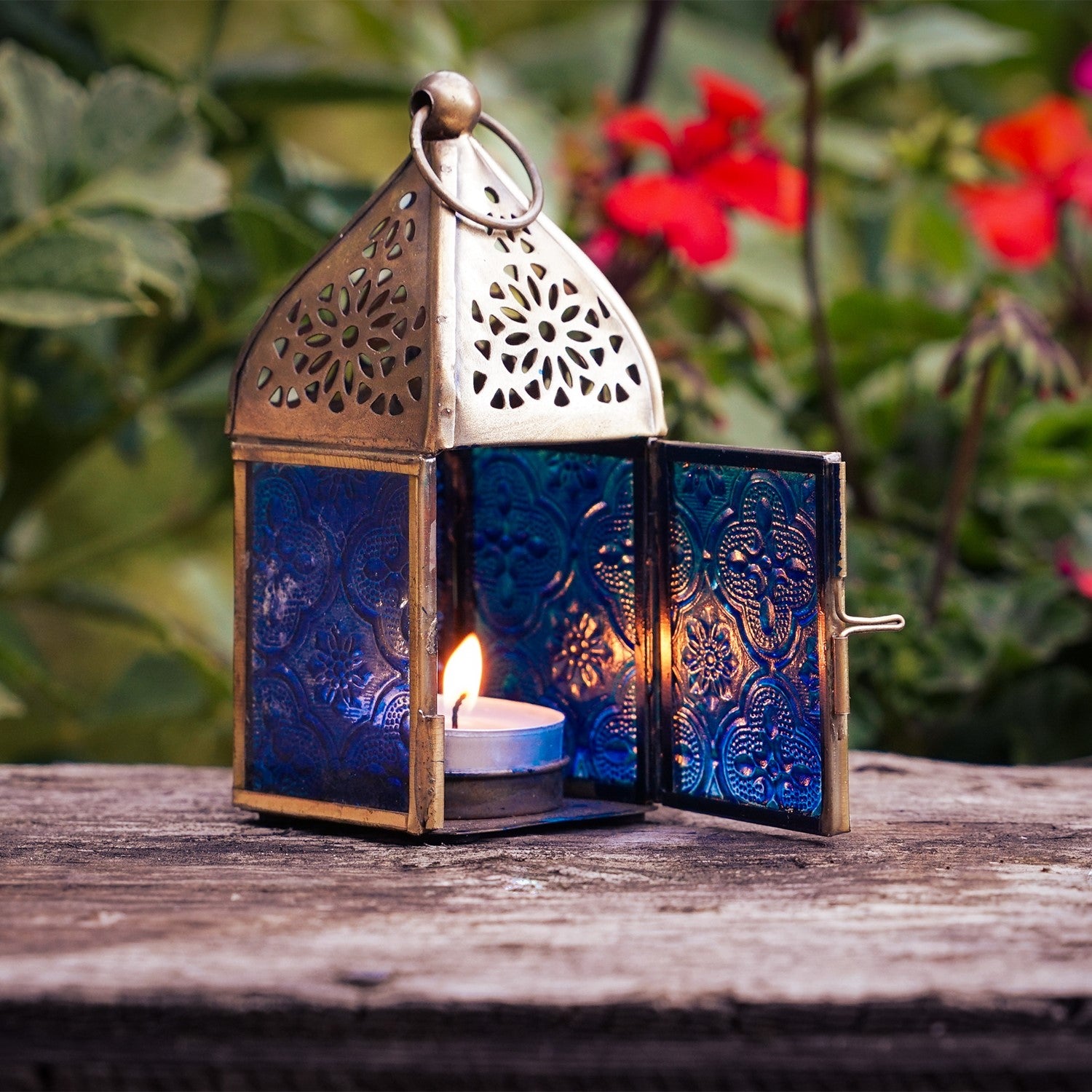 Mini Blue Square Glass Tealight Lantern with textured blue glass panels and a brass top, perfect for creating ambient lighting both indoors and outdoors.
