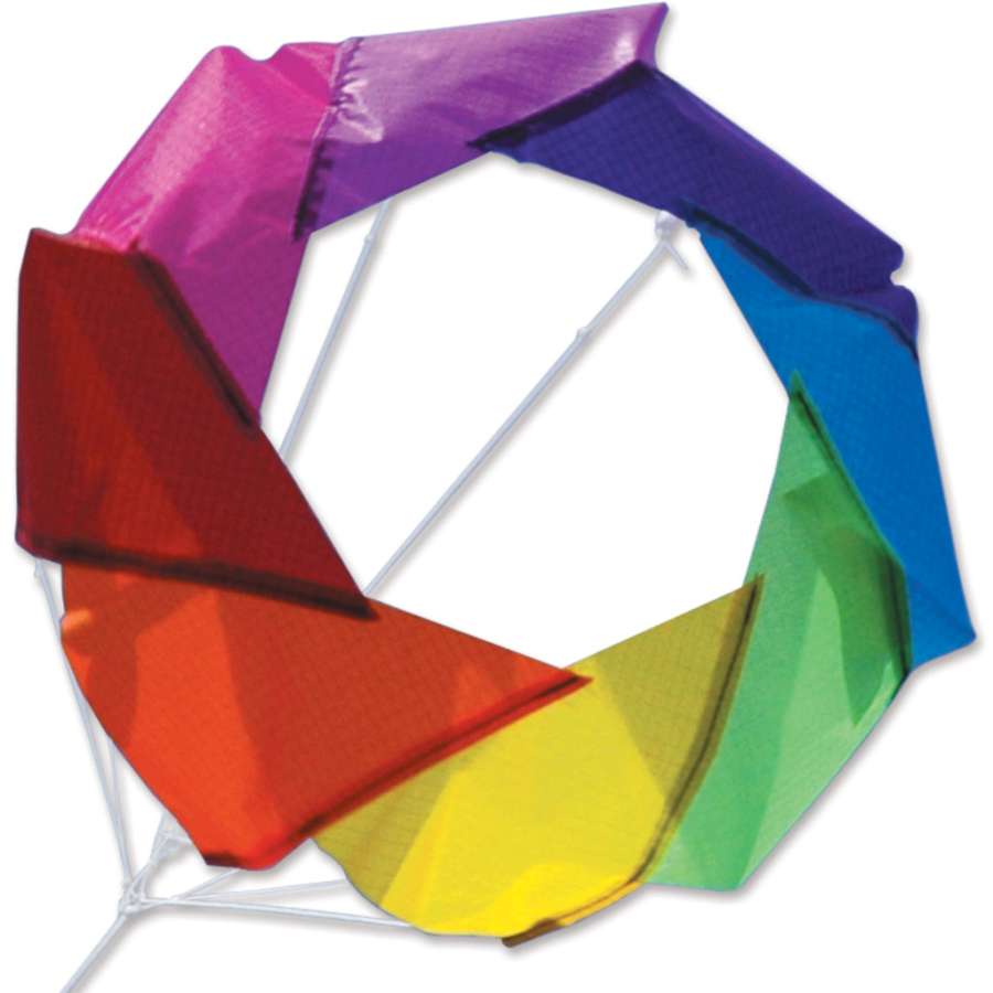 Rainbow Mini F-Stop Spinner for Kites and Line displayed in a backyard setting, showing vibrant colors rotating in the wind.