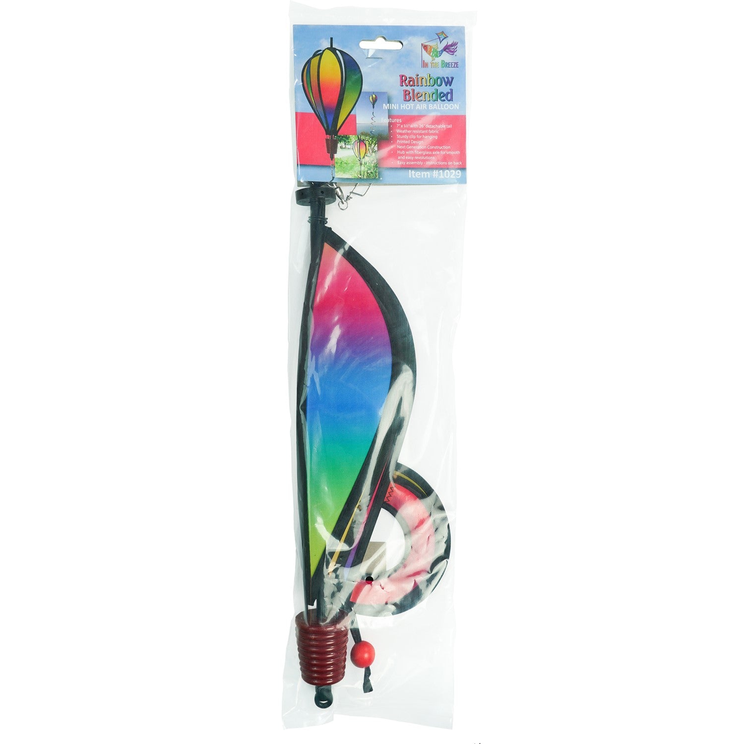 Mini Rainbow Blended Hot Air Balloon spinner with vivid colors floating gently in a garden setting, showcasing its joyful design and curlie tail.
