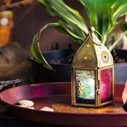 Mini Teal & Pink Pentagon Glass Tealight Lantern showcasing a vibrant design with textured glass panels and metal accents in a cozy indoor setting.