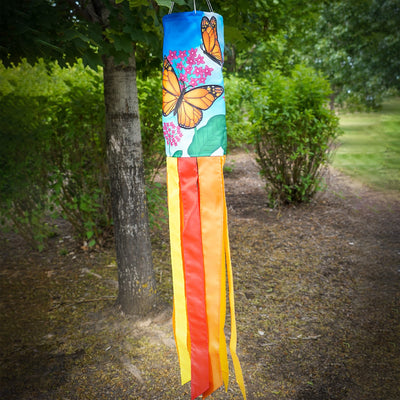Monarch Butterfly 40" Inspiration Windsock featuring vibrant butterfly design and fluttering tails, displayed in an outdoor garden setting.