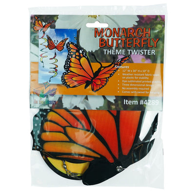 Monarch Butterfly Theme Twister featuring moveable wings and a curlie tail, hanging gracefully in a vibrant outdoor garden setting.
