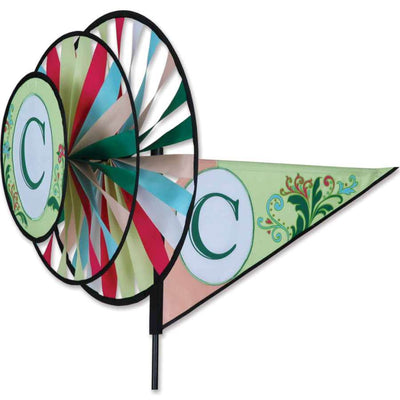 Monogram Triple Spinner featuring the letter C, made from fade-resistant SunTex fabric, elegantly spinning in a garden setting with vibrant colors.