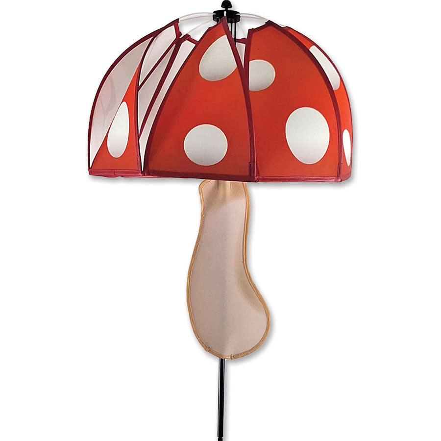 Mushroom Spinner - Red Polka featuring colorful polka dots spinning gracefully in a garden setting, adding whimsy and charm to outdoor decor.