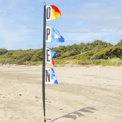Nautical Open 23" x 72" 4-Section Feather Banner displayed outdoors, showcasing vibrant graphics visible from multiple angles.