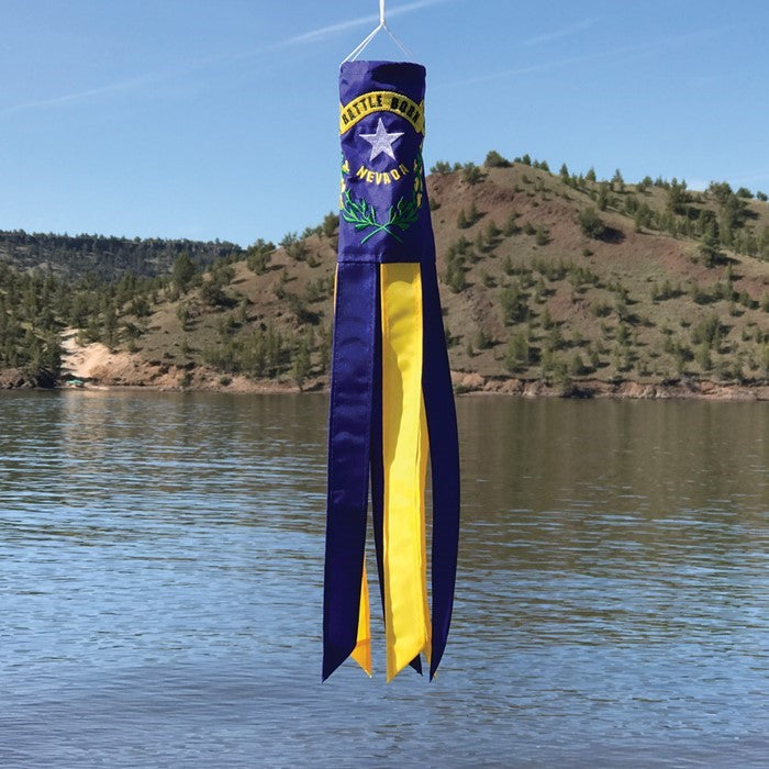 Nevada 18 inch windsock showcasing the state flag with vibrant colors and fluttering tails in a garden setting, celebrating state pride.