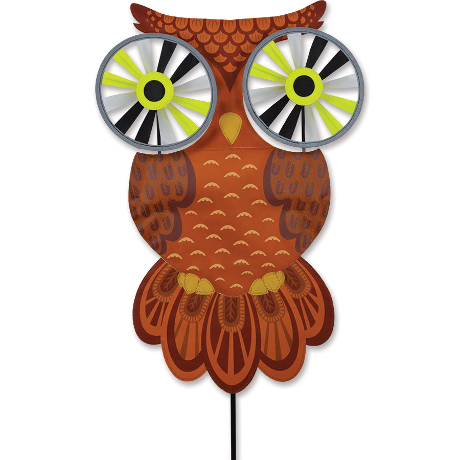 Night Owl Reflective Eyes Spinner with rotating reflective eyes set up in a green garden, showing its whimsical design and sturdy support pole.