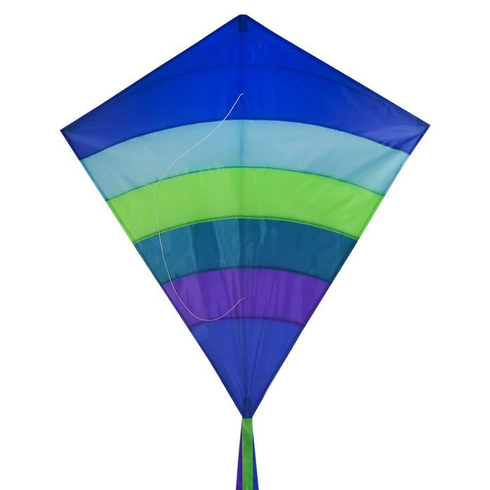 The Ocean Arch 39" Diamond Kite features a stunning blue and ocean-themed design, showcasing its durable ripstop fabric and long tails as it soars high in clear skies.