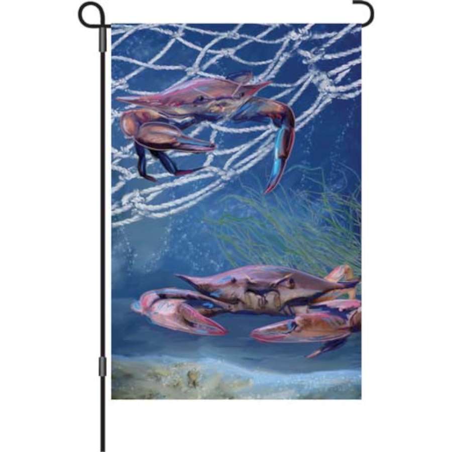 12 in. Ocean Blue Crab garden flag featuring a colorful crab design against a blue ocean backdrop, displayed in a garden setting.
