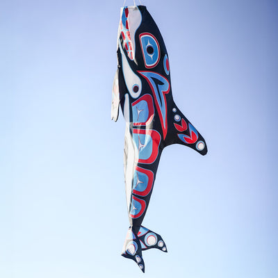 Orca Totem 48" Fish Windsock featuring intricate indigenous design, displayed in an outdoor setting, moving with the breeze.