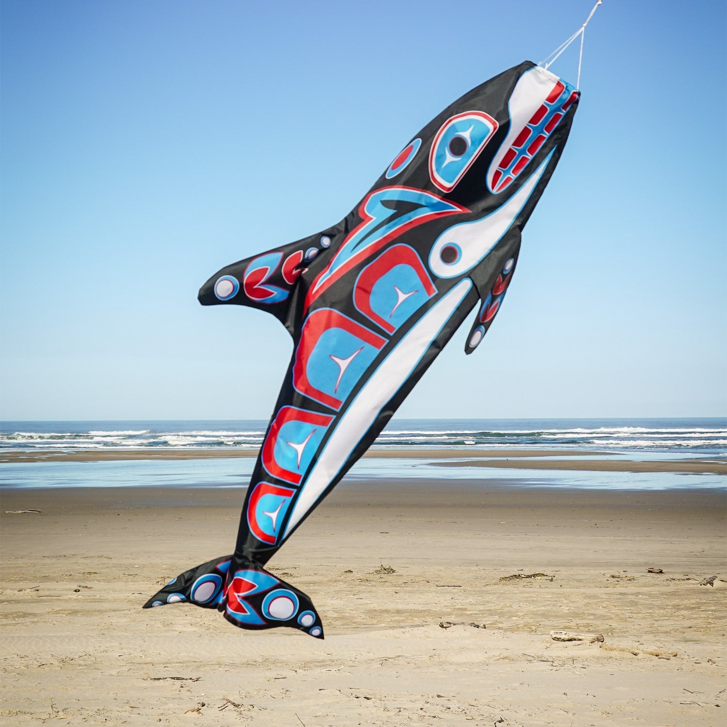 Orca Totem 48" Fish Windsock featuring intricate indigenous design, displayed in an outdoor setting, moving with the breeze.