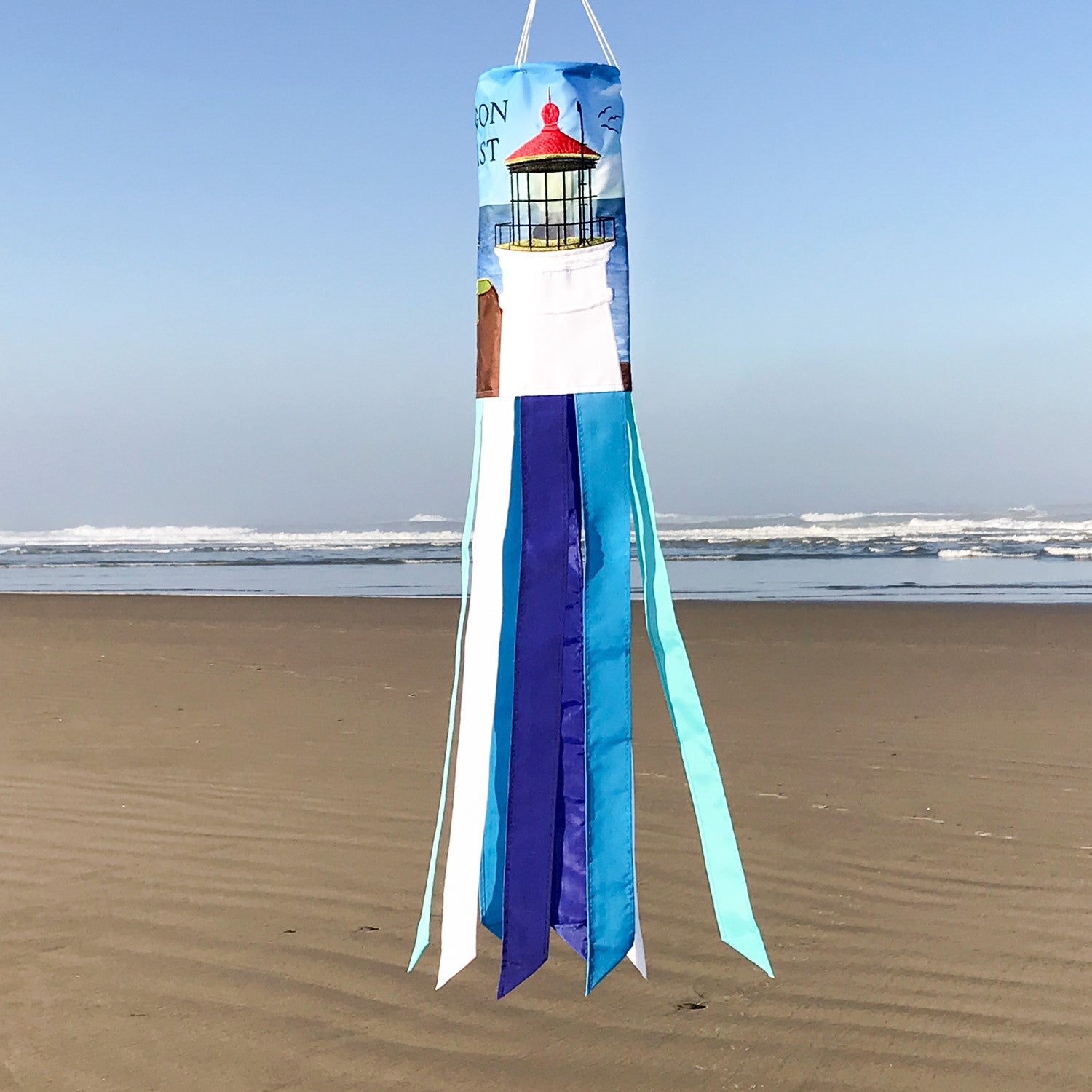 Oregon Coast 40-inch windsock featuring Heceta Head Lighthouse design with colorful applique and embroidered accents fluttering in the breeze.