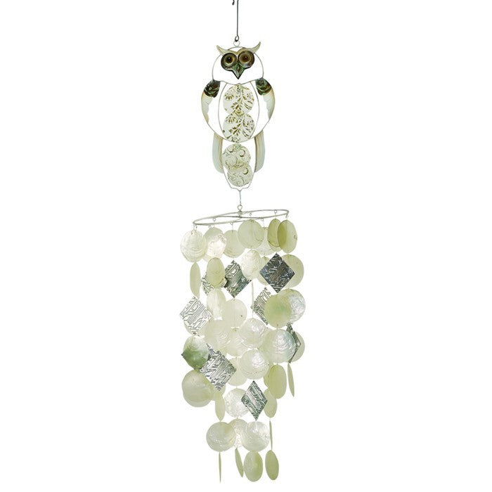 Owl Capiz Breeze Wind Chime made of handcrafted Capiz shells and textured metal displayed on a garden hook in a serene outdoor setting.