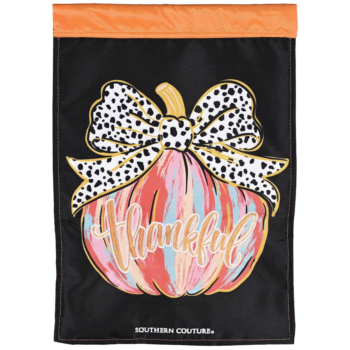 Painted Pumpkin Thankful garden flag featuring vibrant autumn colors beautifully displayed on an outdoor pole in a garden setting.