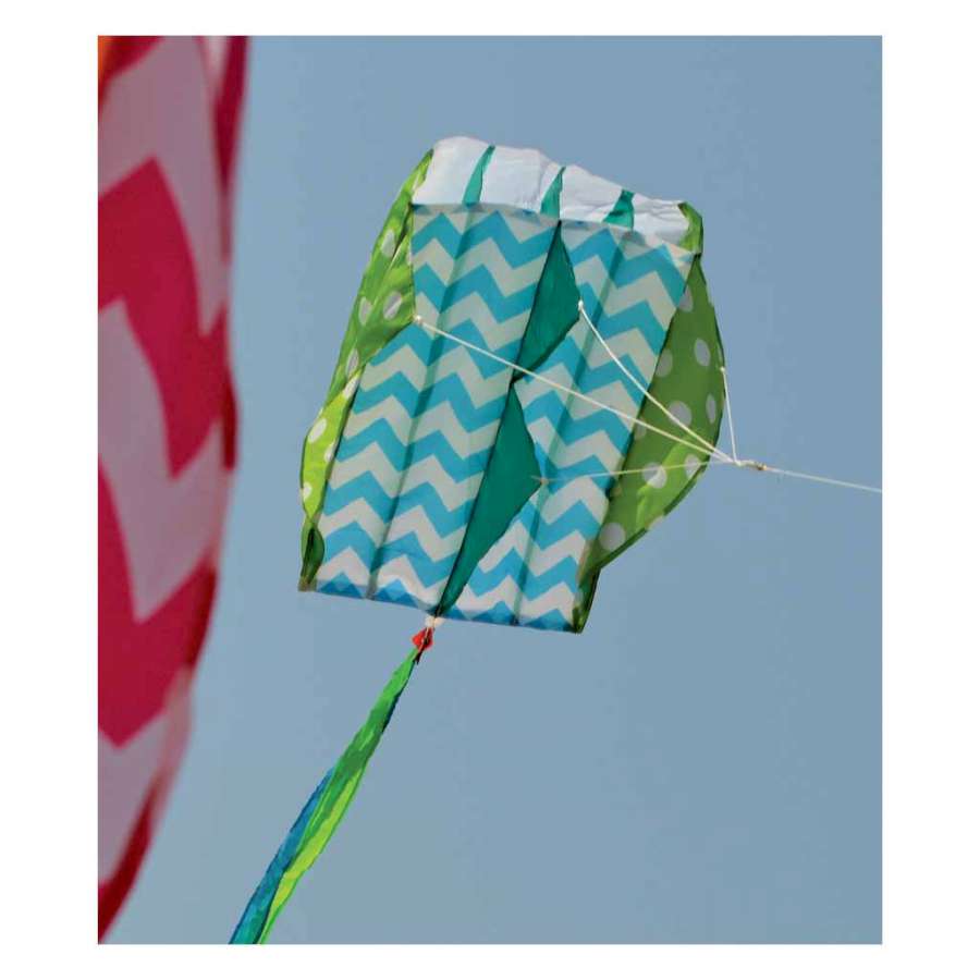 Parafoil 2 kite in vibrant colors being flown in the sky, showcasing its unique frameless design and compact size of 13 x 21 inches.