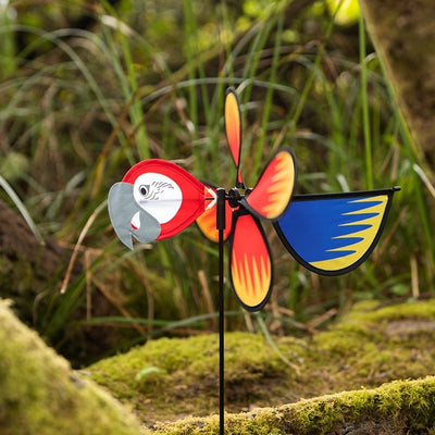Parrot Baby Spinner featuring bright colors and detailed graphics, spinning easily on a 17-inch fiberglass pole in a garden setting.