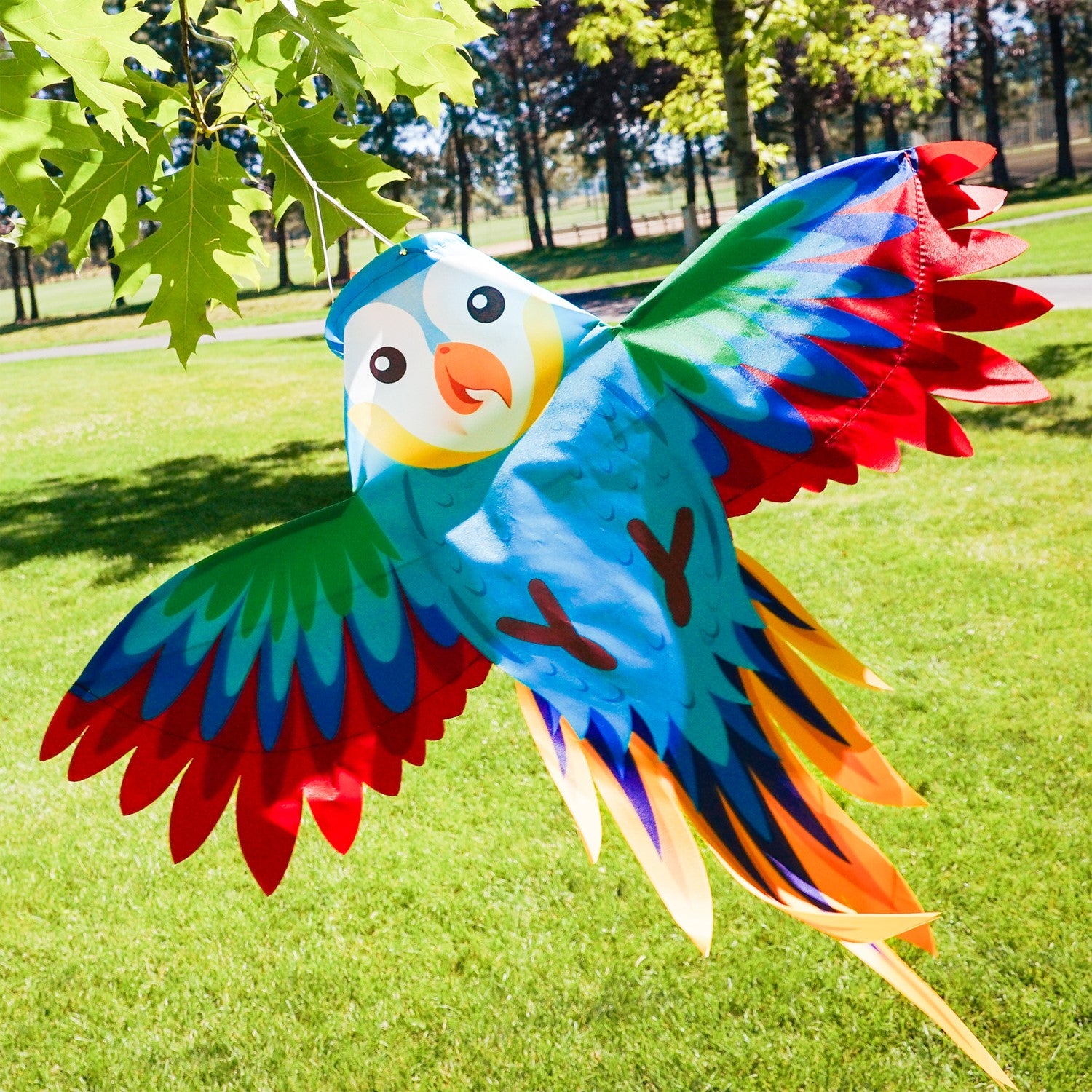 Colorful Parrot Windsock with outstretched wings gracefully hanging outdoors, bringing vibrancy to the garden decor.