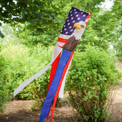 Patriot Eagle 30\" Windsock showcasing a vibrant bald eagle and stars and stripes design hanging in a garden setting.