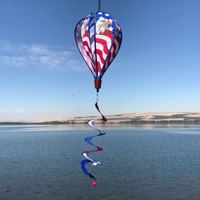 Patriot Eagle Hot Air Balloon kinetic spinner featuring a regal bald eagle against an American flag, displayed in a garden setting.