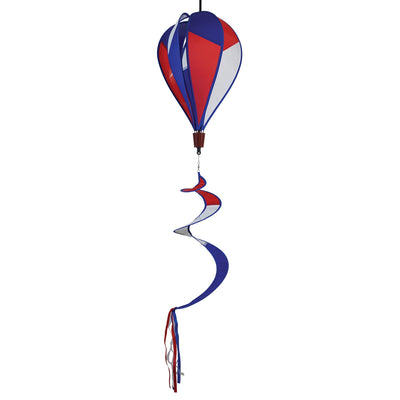 Vibrant Patriot Hot Air Balloon spinner in red, white, and blue colors gently spinning in an outdoor garden setting, showcasing its applique design.