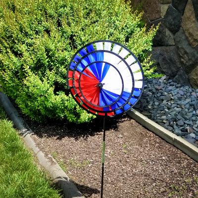 Patriot Triple Wheel Spinner featuring red, white, and blue wheels spinning in the breeze, set on a decorative garden stake.