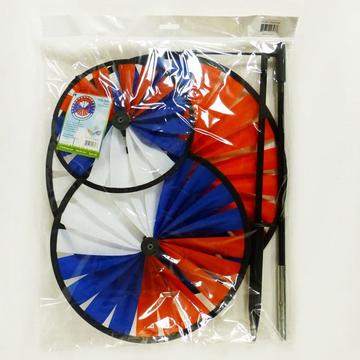 Patriot Triple Wheel Spinner featuring red, white, and blue wheels spinning in the breeze, set on a decorative garden stake.