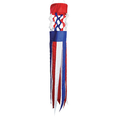 Patriot Twistair windsock featuring red, white, and blue colors with twisted curls, elegantly displayed in a garden setting.